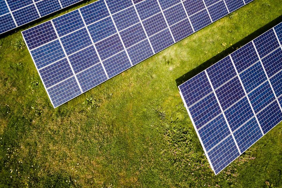 Solar panels on suburban rooftop with clear blue sky