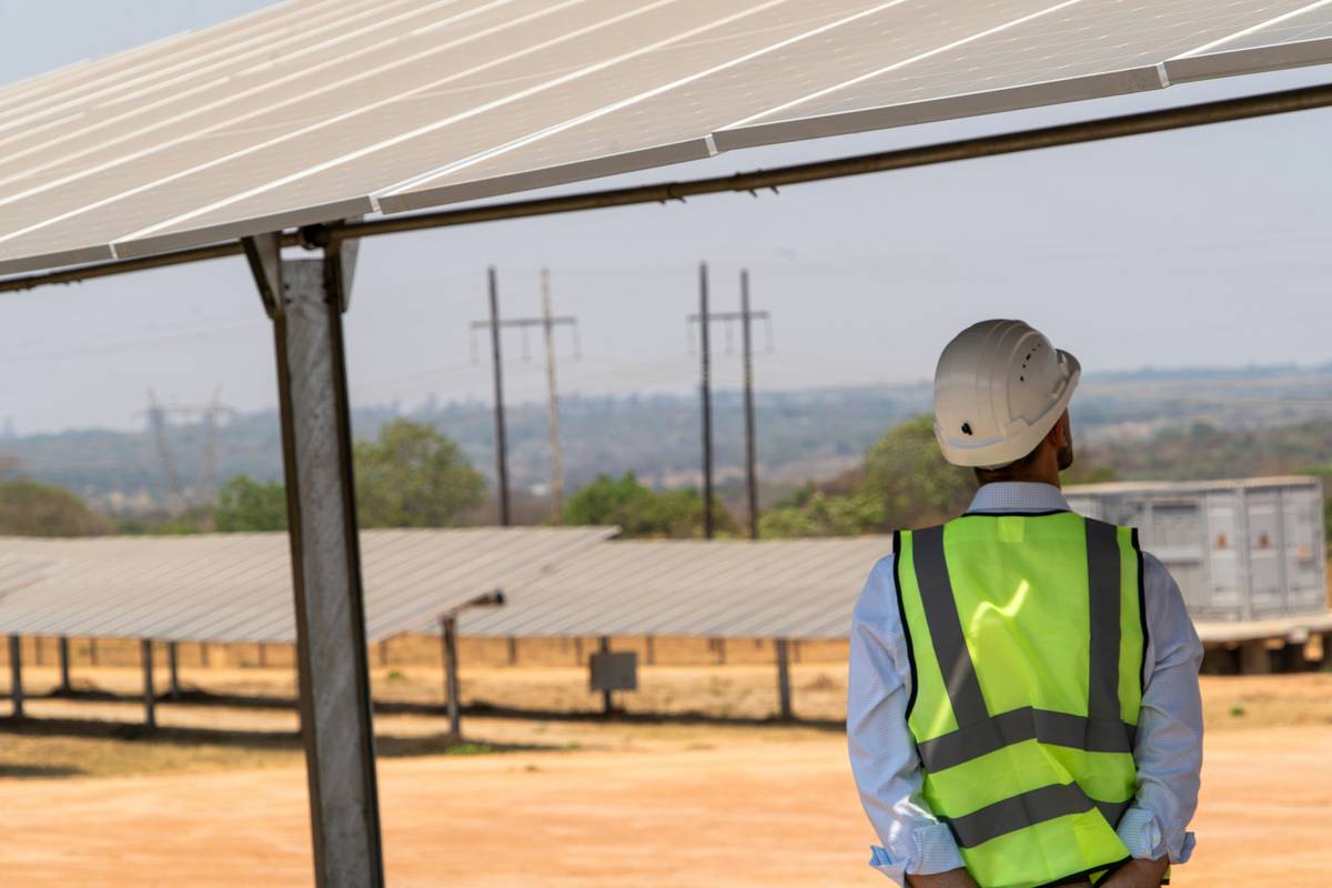 beginners guide to solar panels showing rooftop installation with technician checking panels
